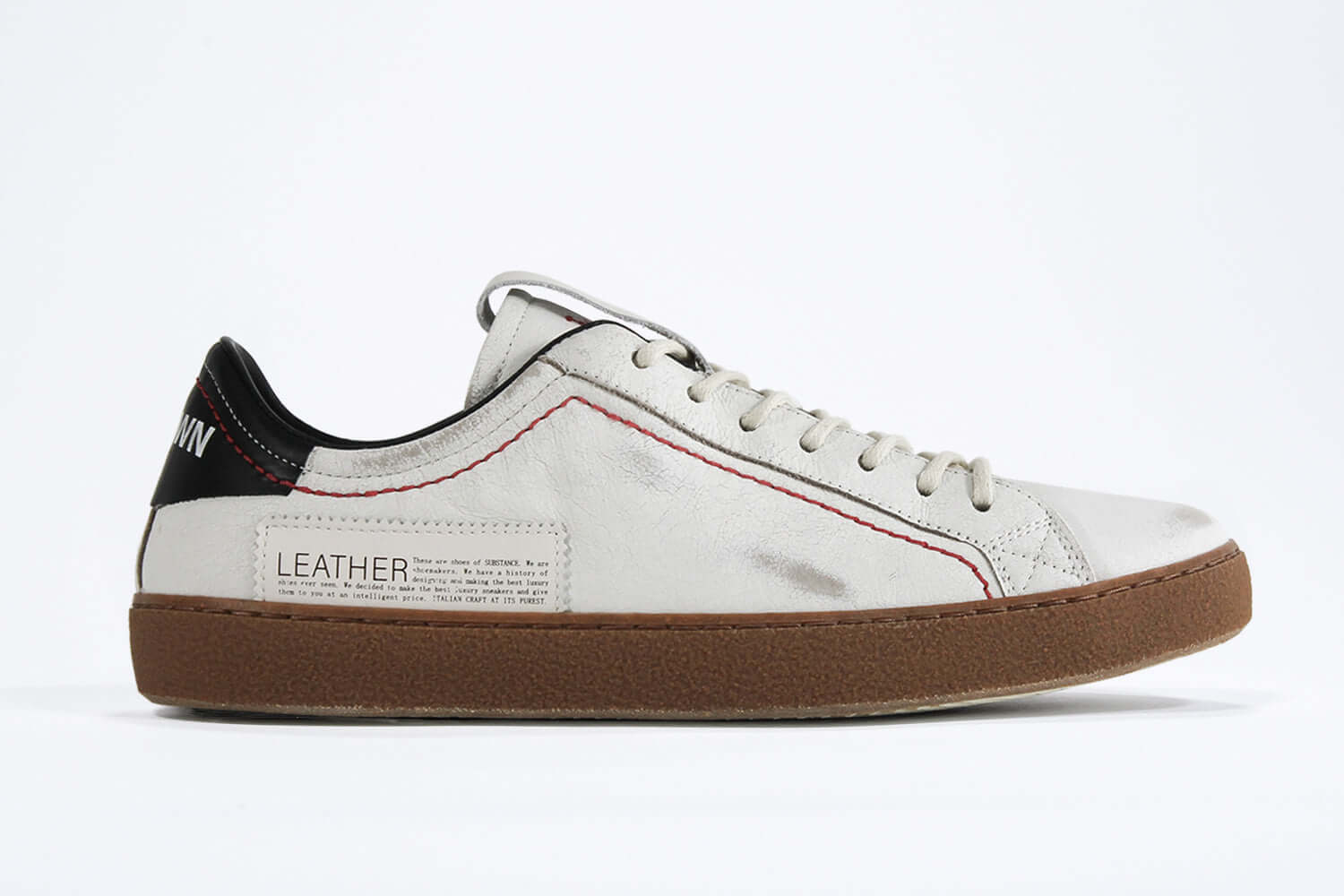 Men's ORIGINAL LC06 Low-top in Retro White Leather, displays the red stitiching and patchwork logo, shown from the side profile.