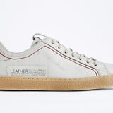Women's ORIGINAL LC06 Low-top in Retro White Leather, displays the red stitiching and patchwork logo, shown from the side profile.