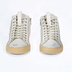 Women's ORIGINAL LC17 High-top Perforated Aged-White Leather sneaker with signature red stitching and a dark natural rubber sole.