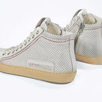 Women's ORIGINAL LC17 High-top Perforated Aged-White Leather sneaker with signature red stitching and a dark natural rubber sole.