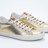 Women's Low-top PURE sneaker in Metallic Gold Leather showing white cotton laces and a low top line.