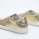 Women's Low-top PURE sneaker in Metallic Gold Leather shown from the back, displaying the Italian craftsmanship.