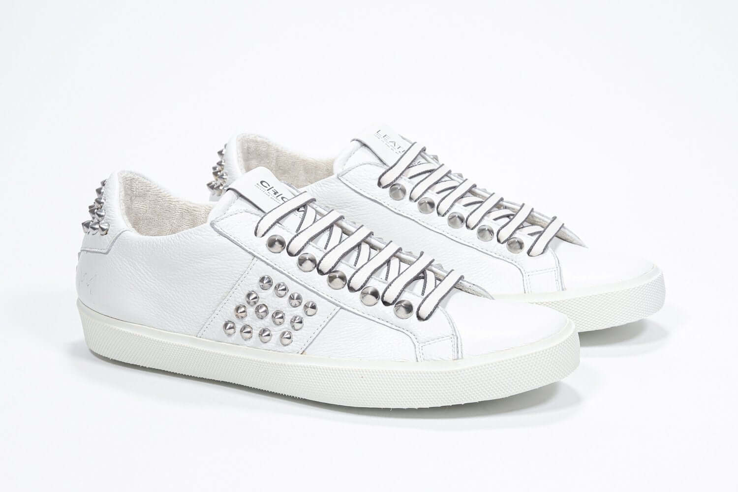  Women's Low-top STUDLIGHT in White Leather and Silver Studs sneakers offers an edgy and clean silhouette.
